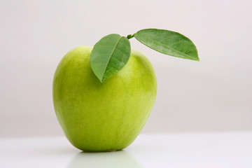 Close-up of a ripe granny smith apple isolated on a light grey