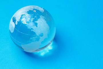 A glass globe, isolated on blue background