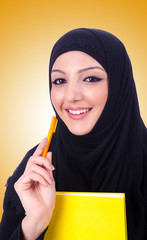 Young muslim woman with book on white