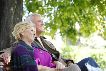 Fototapeta na wymiar Smiling senior couple relaxing outdoor