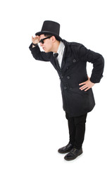 Young detective in black coat isolated on white