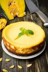 Homemade pumpkin cheesecake on wooden background,Thanksgiving day