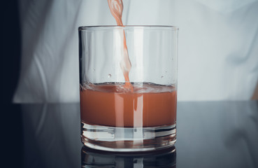 Bartender is making cocktail. Toned image.
