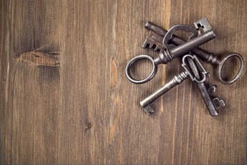 Old keys at right top of wooden background