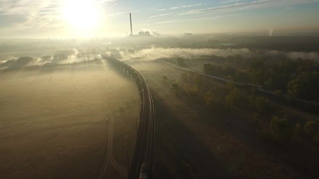 Train in the morning fog with a bird's eye view