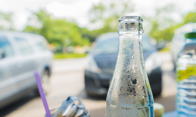 Clear glass cold bottle in sunny day