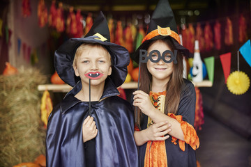 Witch and wizard in scary masks on