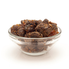 Front view of Organic Indian bdellium or Guggul resin (Commiphora wightii) in glass bowl isolated on white background.