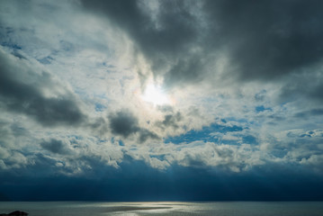 Fototapeta na wymiar Dark gray dramatic sky near the ocean