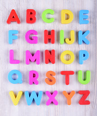 colorful plastic English alphabet on a white wooden background - 93364276