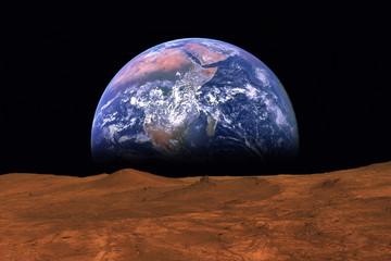 Imaginary view of earth rising from the horizon of plant Mars. Elements of this image are furnished...