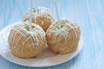 Caramel apple covered with white chocolate