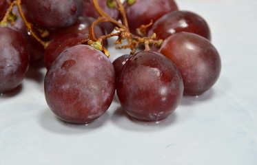 red grape on white tile