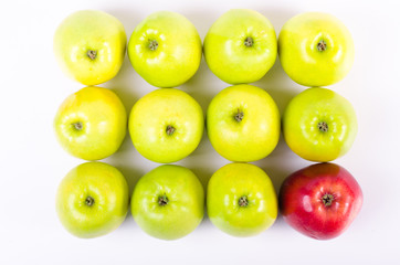 Background of green apples with one red apple