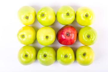 Background of green apples with one red apple
