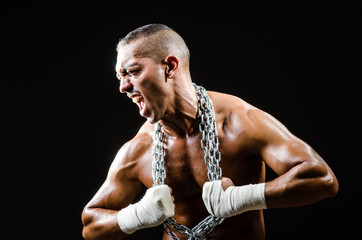 Fototapeta na wymiar Muscular man with metal chain
