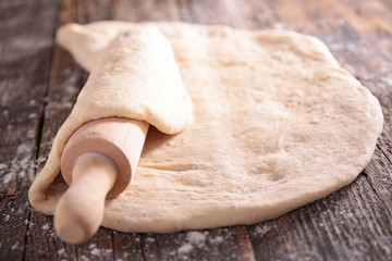 raw dough and rolling pin