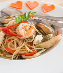 Spicy sea food spaghetti on white dish