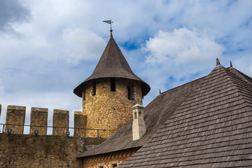 Fototapeta na wymiar old castle tower on a blue sky background