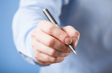 Businessman's hand holding a pen