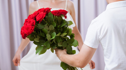 Man  giving roses to young woman