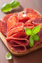 salami slices in wooden plate