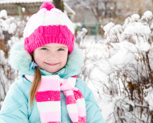 Portrait of smiling little girl in winter day