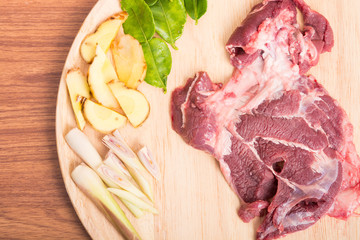 fresh raw beef meat slices on wooden