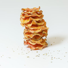 A pile of homemade baked sweet potato chips stacked over. A healthy sweetpotato vegetarian crisp...