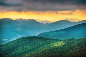 Fototapeta premium Sunset over blue mountains