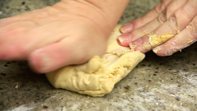 Profile close up of kneading dough to make fresh pasta.