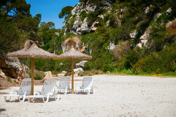 chaise longues at sandy beach