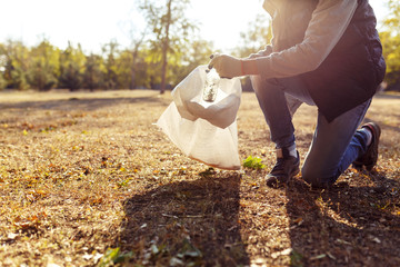 young man picking up trash