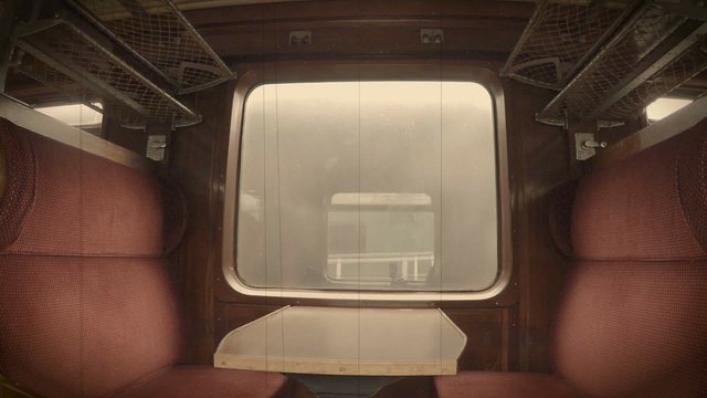 Steam viewed through a window from inside a old railway carriage. Processed to look like vintage film.