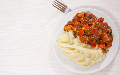 meat in sauce with mashed potatoes