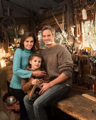 Portrait of family working a rustic wooden workshop 