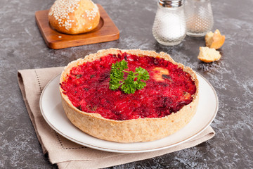 Beetroot pie with feta cheese on white plate