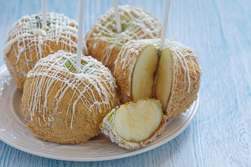 Caramel apple covered with white chocolate