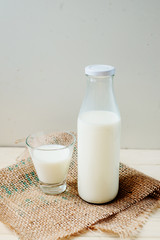 
A light breakfast of milk products , cottage cheese, sour cream and milk, roll and butter on a wooden background