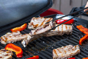 Meat and sweet paprika on a gas grill

