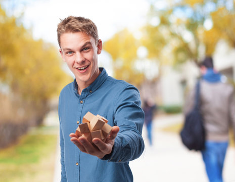 young man holding a puzzle - Powered by Adobe