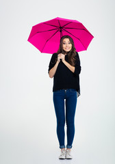 Smiling woman standing under umbrella