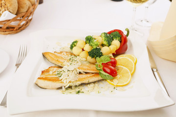 Tasty prepared fish fillet with vegetable and almond. Delicious dinner.
