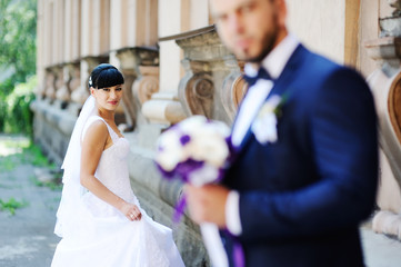 the bride and groom on the background of an old building with co