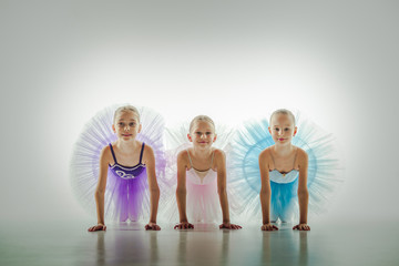 Naklejka premium Three little ballerinas in dance studio