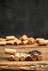 Wine corks and corkscrew on a wooden table