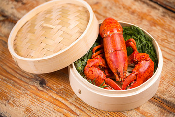 A delicious freshly boiled lobster in bamboo steamer