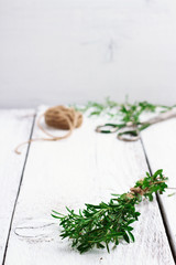 Fresh herbs (savory) on a wooden table