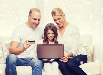 happy family with laptop computer and credit card