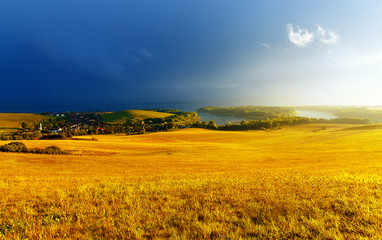 Fototapeta premium Beautiful landscape, yellow meadow and lake with mountain